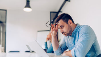 Frustrated person looking at his laptop